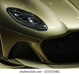 Golden sports car headlight and spoiler