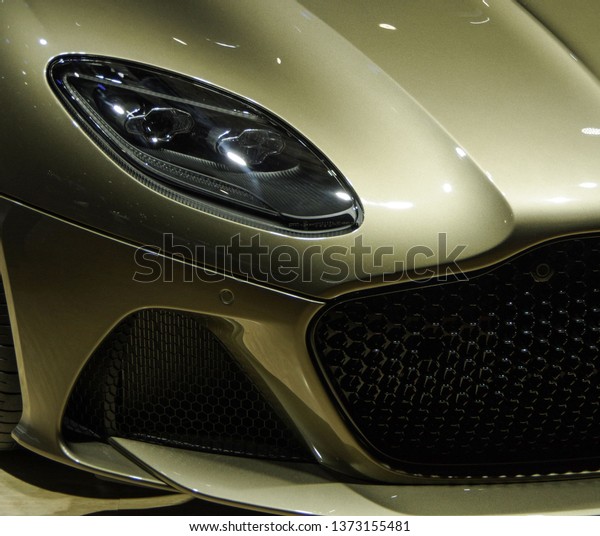 Golden sports car\
headlight and spoiler