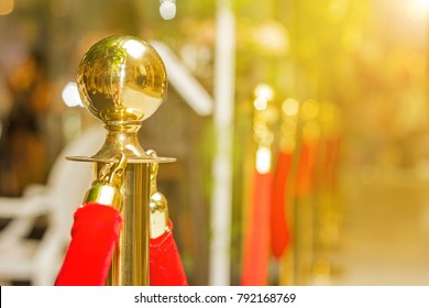 Golden stanchions with a red rope. Barrier, enclosed VIP area, protected entrance, private event, luxury gala concept. - Shutterstock ID 792168769