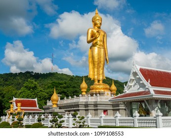 Golden standing Buddha at the peak at Hat Yai Municipality Park in Hat Yai, Songkhla Province in the south of Thailand.