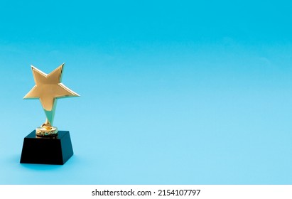 Golden Star Trophy On Blue Background.