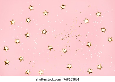 Golden stars glitter on pink background. Festive holiday pastel backdrop. - Shutterstock ID 769183861