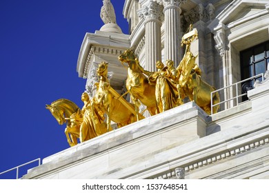 Golden Statues of progress of the state on top of capitol building  