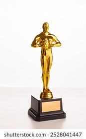 Golden statuette of the cinema award on white. a place for an inscription on a figurine. copy space. oscar