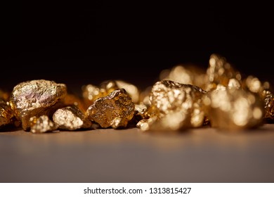 golden stones on marble isolated on black