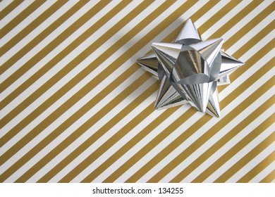 Golden Striped Wrapping  Paper With A Silver Bow