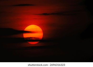Golden sun setting through dramatic clouds at dusk, spreading warm light across the sky — a serene and spiritual moment symbolizing peace, transition, and divine energy.
