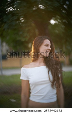 Similar – Image, Stock Photo Golden sunlight filters through a dynamic field of wheat with red poppies, creating a blurred, dreamlike effect