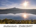 Golden sunrise light reflecting on Lake Albano in Castel Gandoldo Italy. 