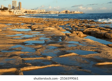 Golden sunrise on the rocky seashore of Malta with sea, sky and rocky shore in the background - Powered by Shutterstock