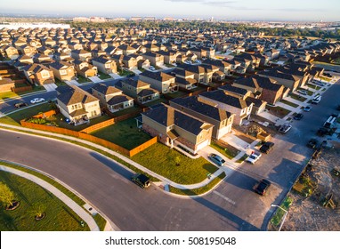 Golden Sunrise with row after row of Surburbia Houses Aerial Sunrise Over New Development Suburban Homes in North Austin Texas 