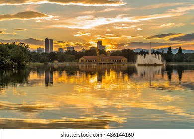 Golden Sunset at City Park - A summer sunset view of Ferril Lake in Denver City Park, with city skyline and front range mountains in the background, at east-side of Downtown Denver, Colorado, USA.