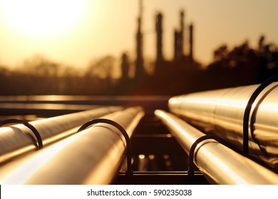 golden sunset in crude oil refinery with pipeline system - Shutterstock ID 590235038