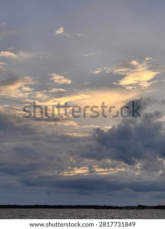 Golden Sunset Light Through Clouds Over Ocean