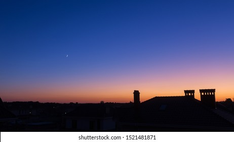 Golden Sunset. Only The Silhouettes Of The Houses Are Visible In Orange Sky. Orange Evening Sunset Sky Above House Roof With Small Suburban Houses At Horizontal Line