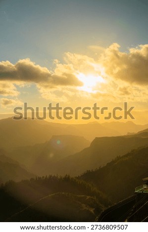 Golden sunset over mountains with dramatic clouds