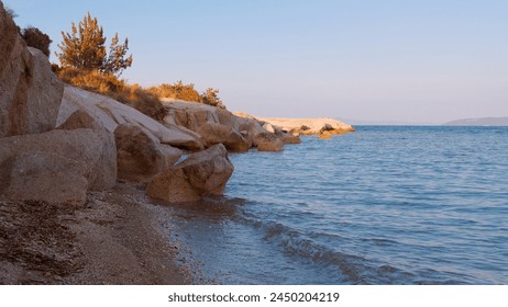 Golden Sunset Over Rocky Shoreline, Tranquil Rocky Shoreline and Pebble Beach at Sunset,  - Powered by Shutterstock