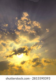 Golden Sunset Sky with Dramatic Clouds and Radiant Sunbeams