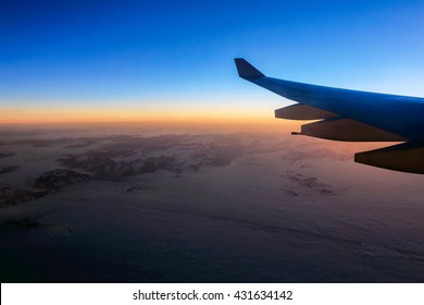 Golden Sunshine In Sky At Sunset Outside Plane Window 