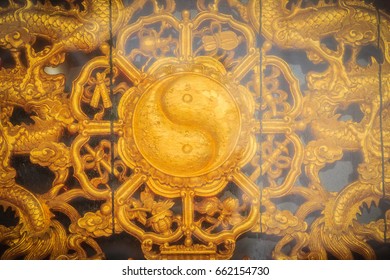 Golden symbol of Yin - Yang on the wall of Chinese temple in Thailand.