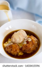 Golden Syrup Dumplings With Custard.  Classic Australian Dessert.