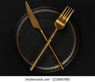 The golden tableware is placed on a ceramic dinner plate. The background is black leather. Luxurious, sumptuous fine tableware.Flat lay, top view, banner,horizontal photo
 - Shutterstock ID 2218687085