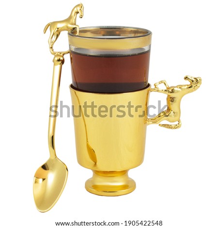 Golden tea cup on saucer for Islamic Muslim holidays decoration Ramadan decoration. Isolated on white background