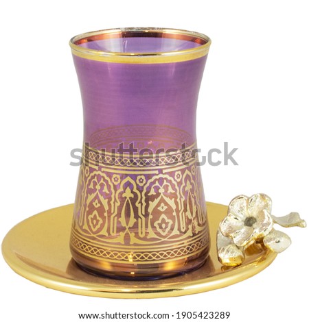 Golden tea cup on saucer for Islamic Muslim holidays decoration Ramadan decoration. Isolated on white background
