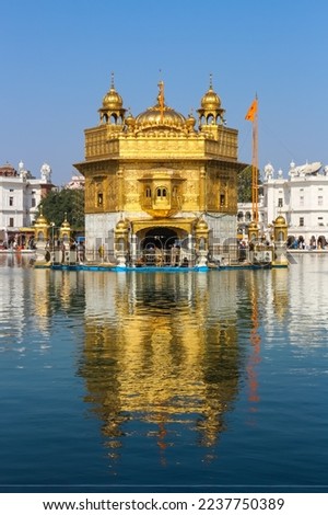 Golden Temple Amritsar closeup with it's reflection in blue water holy pond Punjab Tourism with blue sky