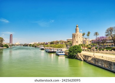 Golden Tower (Torre del Oro) with Guadalquivir River in Seville during a Sunny Day, Andalusia, Spain  - Powered by Shutterstock