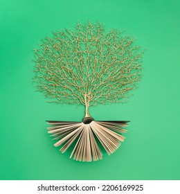 Golden Tree Growing From The Old Book, Education And Knowledge Concept. For Book Lovers. Flat Lay.