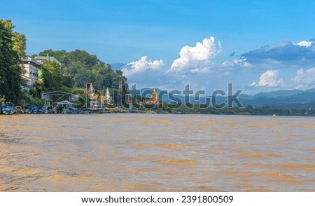 Golden Triangle the 3 borders of Thailand Laos and Myanmar lovely Golden Buddha on the Mekong River with boats in the river and mountains in the background 