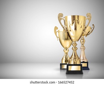 golden trophies on gray background