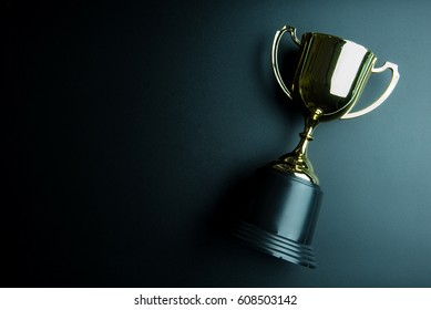 Golden trophy isolated on black background with copy space.Concept winner