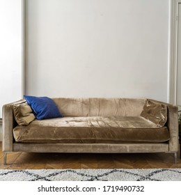 Golden Upholstered Bench In Front Of A White Wall.