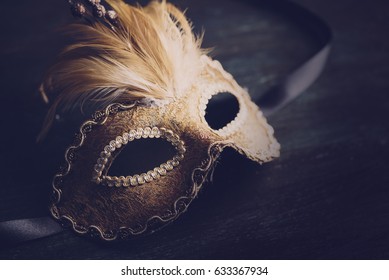 Golden Venetian Ball Mask Over Dark Background With Copyspace. Masquerade Party Or Holiday Event Celebration Concept.