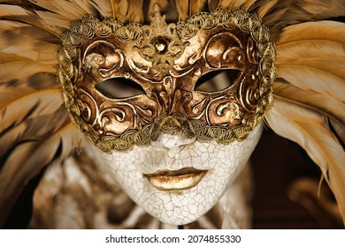 golden venetian mask with feathers
