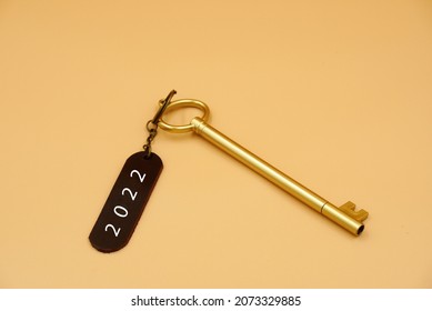 Golden vintage key with Keychain  or Keyring label 2022 word on yellow background. Key to success 2022 concept. Start planning with new idea , tag 