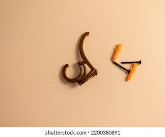 Golden Wall Hook With Screw And Plugs On Isolated White Background