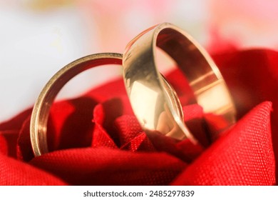 Golden wedding rings on red bridal bouquet. Close-up - Powered by Shutterstock