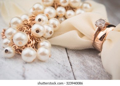 Golden Wedding Rings On White Wood Background