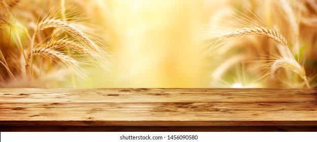 Golden Wheat Field With Rustic Wooden Table For Thanksgiving 