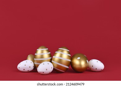 Golden and white easter eggs painted with stripes and dots at bottom of dark red background with copy space