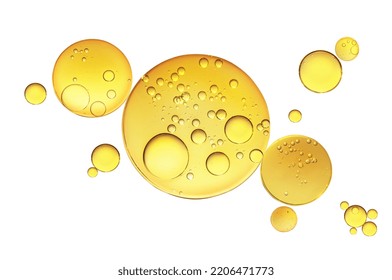 Golden yellow abstract oil bubbles or face serum isolated on white background. Oil bubbles macro photography. - Shutterstock ID 2206471773