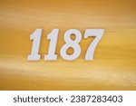 The golden yellow painted wood panel for the background, number 1187, is made from white painted wood.