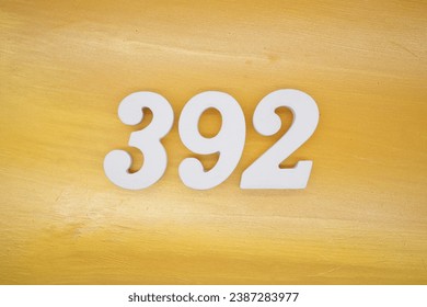 The golden yellow painted wood panel for the background, number 392, is made from white painted wood.