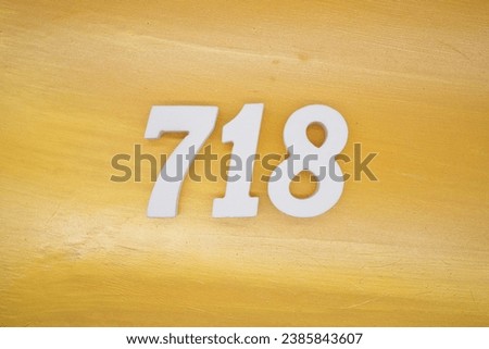 The golden yellow painted wood panel for the background, number 718, is made from white painted wood.