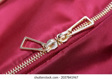 Golden Zipper Close Up View. Buttoned Metal Zipper On Backpack Or Clothes.