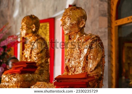 Gold-leaf covered statue of the monks that founded Wat Chalong, a 19th century Buddhist temple on Phuket island in Thailand, Southeast Asia