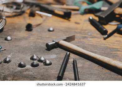 Goldsmith desktop. Jeweler's workbench with hammer and different tools - Powered by Shutterstock